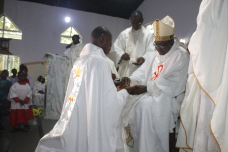 Anointing of Fr John Irekiigbe's hands with chrism oil