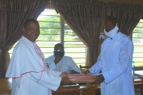Mnsgr Emmanuel Yakubu, the former chairman for the commission handing over to Rev Fr Dr Francis Oladiipo, the new chairman for the commission.