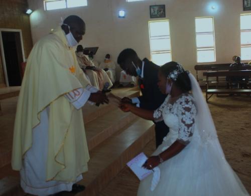 Very Rev. Fr Boniface Wuraola, presenting the Bishop's gift to the newly married Mr and Mrs James Ajayi on Saturday 11th July, 2020 at St Michael's Okeho.